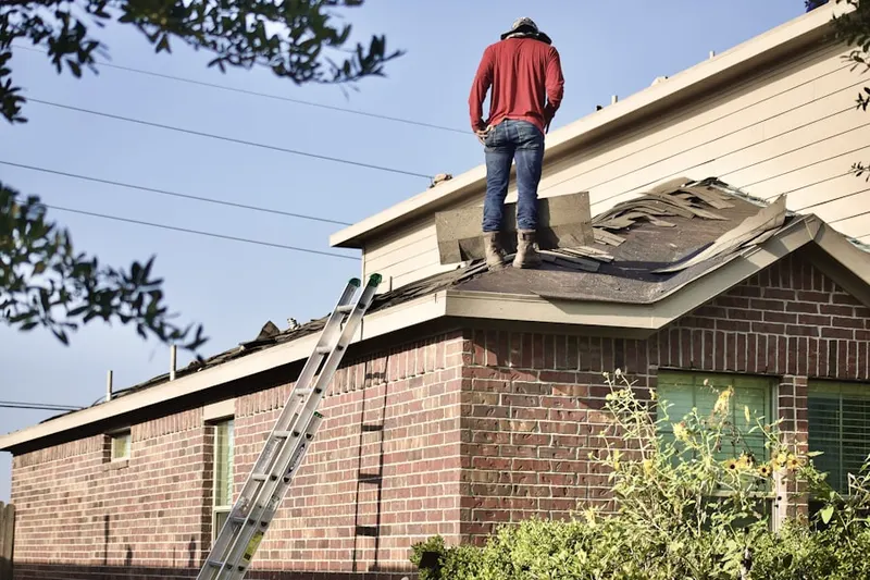 Professional roofer working on a residential roof in North Forest